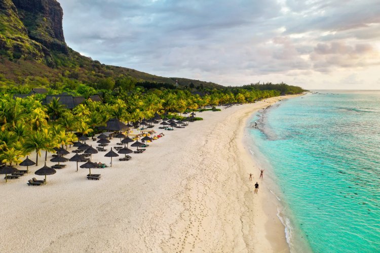 View from the height of the island of Mauritius in the Indian Ocean and the beach of Le Morne-Brabant and the family on the beach